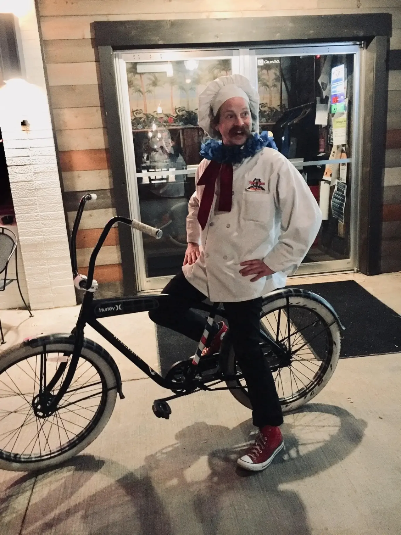 Killian's chef outside the restaurant Killian's chef posing with a bicycle outside the Spearfish, SD restaurant in the Black Hills
