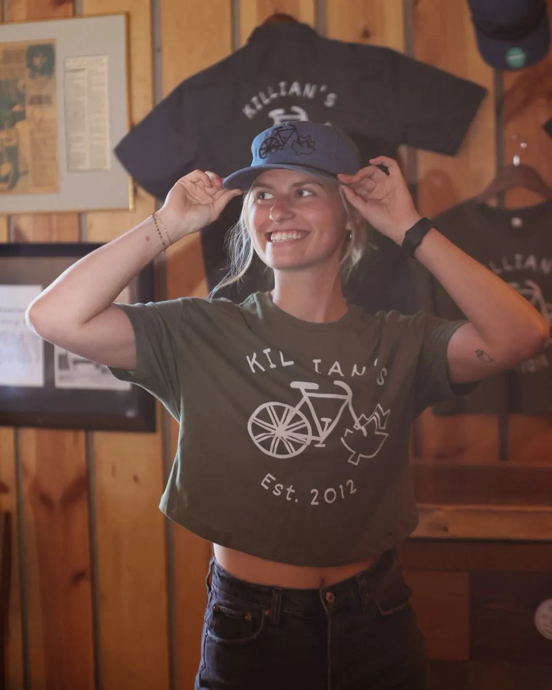 Guest smiling in a green Killian's Est. 2012 t-shirt and blue baseball cap at the Spearfish, SD restaurant