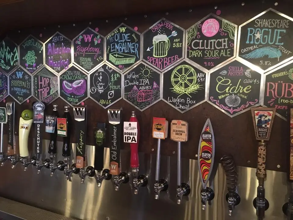 17 craft beer taps lined up at Killian's Spearfish bar with chalkboard tap list above